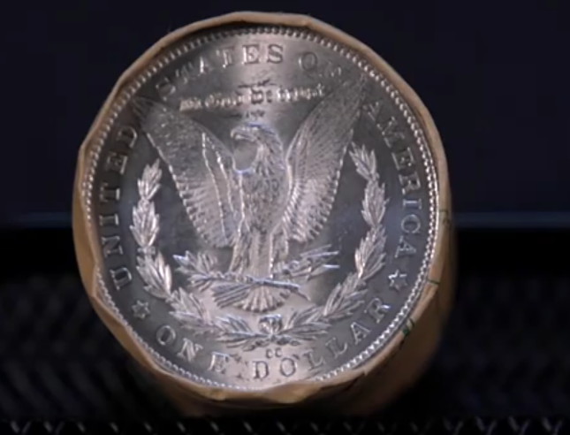 Morgan Dollar Roll 1879 On One Side CC On The Other Side Against A Black Background