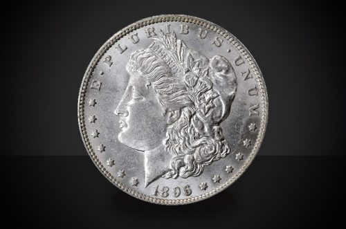 1896 O Morgan Dollar Choice Borderline Uncirculated Coin Against a Black Background